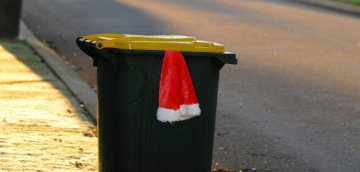 Image of santa hat hanging out a bin